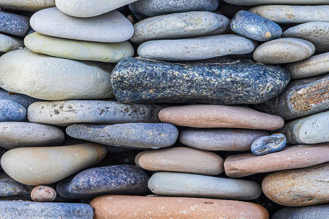 Image for Colorful stones stacked tightly together, each supporting the others under pressure — symbolizing how authentic messaging in healthcare crisis communication builds a strong, trustworthy foundation when it matters most.teaser