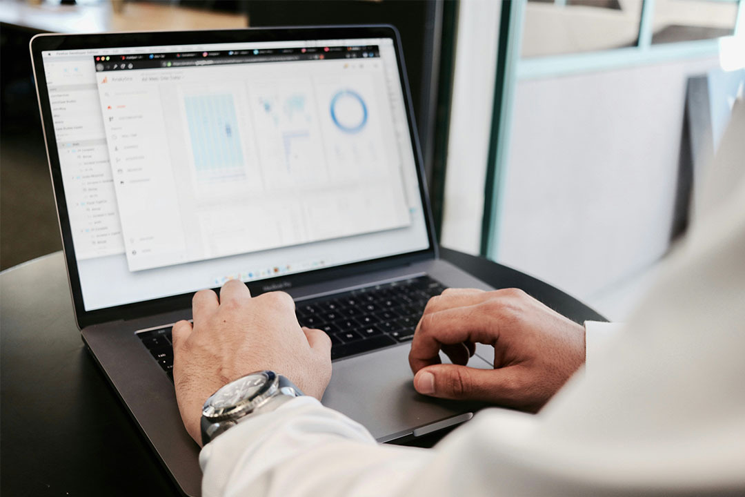 Image for Businessman entering data on a laptop, symbolizing how smarter data empowers healthcare organizations to drive growth, align strategy, and control costs.teaser